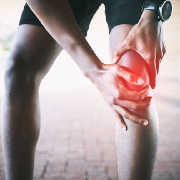 Person holding their knee in pain